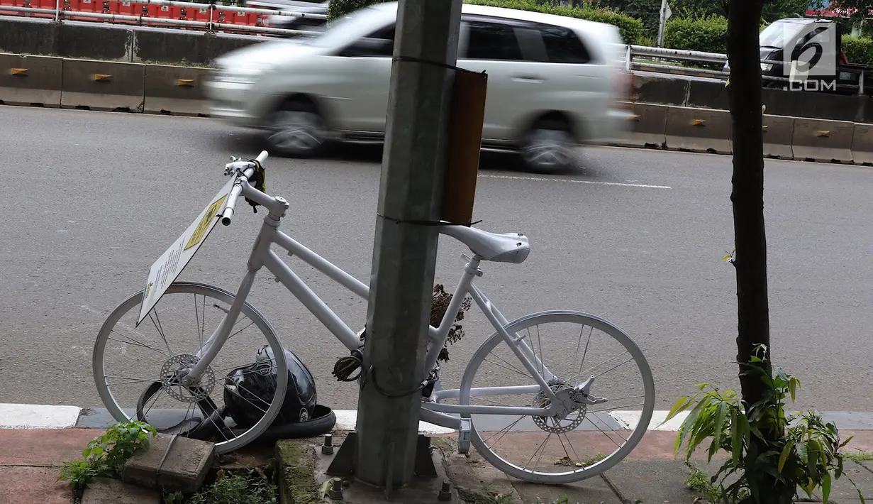 Monumen sepeda putih atau ghost bike bersandar di sebuah tiang kawasan Jenderal Gatot Subroto, Jakarta, Senin (12/3). Monumen itu untuk mengenang pesepeda Raden Sandy Syafiek yang tewas tertabrak mobil. (Liputan6.com/Immanuel Antonius)