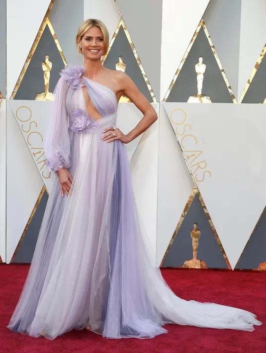 Supermodel Heidi Klum memilih gaun warna lavender, aksen cutout di dada dan ornamen bunga besar di pundak dan pinggang yang terlihat mengganggu, saat berpose di red carpet Piala Oscar 2016 di Hollywood, California, Minggu (28/2). (REUTERS/ Lucy Nicholson)