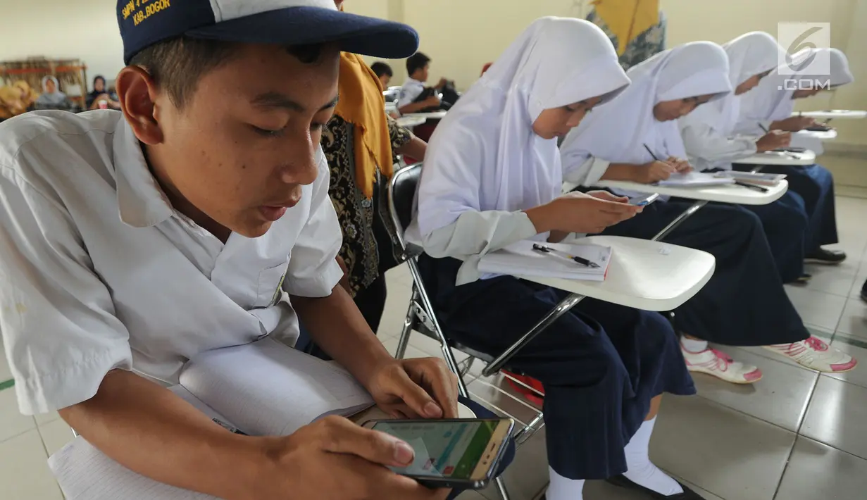 Pelajar menggunakan ponsel android mengikuti babak penyisihan lomba matematika dengan metode Gasing (Gampang Asyik & Menyenangkan) di SMKN 1 Leuwiliang, Bogor, Selasa (8/1). (Merdeka.com/Arie Sunaryo)