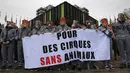 Para pemrotes mengenakan pakaian penjara dan topeng binatang menggelar spanduk saat melakukan aksinya di Strasbourg, Prancis (12/4). (AFP/Frederick Florin)