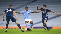 Pemain Manchester City Raheem Sterling (tengah) berebut bola dengan pemain Arsenal Granit Xhaka (kiri) dan Dani Ceballos pada pertandingan Liga Premier Inggris di Etihad Stadium, Manchester, Inggris, Sabtu (17/10/2020). Manchester City menang 1-0. (Michael Regan/Pool via AP)