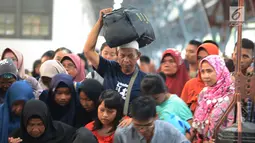 Penumpang kereta api Tawang Jaya Semarang tiba di Stasiun Pasar Senen, Jakarta, Sabtu (8/6/2019). Volume penumpang arus balik melalui moda transportasi kereta api  di stasiun Stasiun Senen mengalami lonjakan pada H+3 Lebaran. (merdeka.com/Imam Buhori)