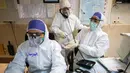 Seorang petugas medis membersihkan tangan rekannya di sebuah rumah sakit yang menangani pasien virus corona atau COVID-19 di Teheran, Iran, Minggu (1/3/2020). Sejauh ini, Iran mencatat ada 1.501 kasus virus corona dengan 66 korban meninggal. (Koosha Mahshid Falahi/Mizan News Agency via AP)