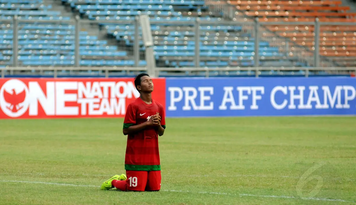 Pemain depan timnas U-16 Indonesia, Kevin Sahali bersimpuh usai mengalahkan timnas U-16 Vietnam pada laga persahabatan di Stadion GBK Jakarta, (3/12/2014). Indonesia unggul 3-2 atas Vietnam. (Liputan6.com/Helmi Fithriansyah)