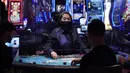 Para pengunjung bermain blackjack saat pembukaan kembali hotel dan kasino Bellagio di Las Vegas, Nevada, Amerika Serikat, Kamis (4/6/2020). Kasino di Nevada diizinkan kembali beroperasi setelah penutupan sementara untuk mencegah penyebaran virus corona COVID-19. (AP Photo/John Locher)