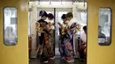 Wanita Jepang berkimono menaiki kereta usai mengikuti upacara Coming of Age Day (Hari Kedewasaan Nasional) di taman hiburan Tokyo, Senin (11/1). Hari Kedewasaan Nasional ini dirayakan para muda-mudi Jepang yang menginjak usia 20 tahun (REUTERS/Yuya Shino)