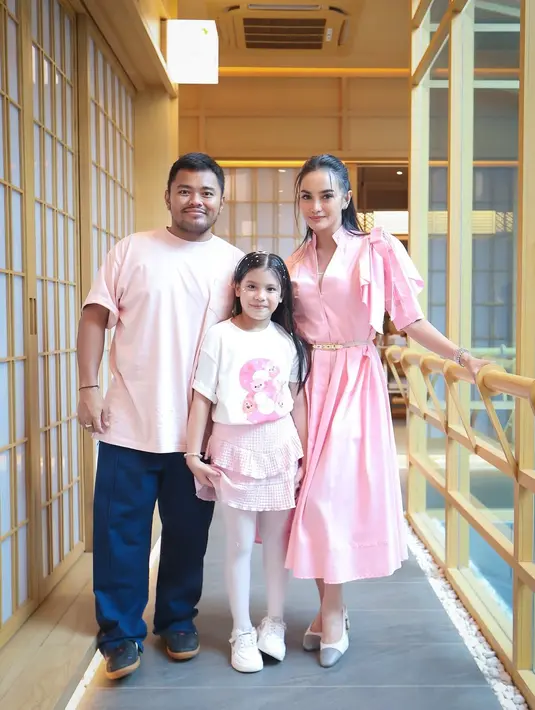 Tidak ketinggalan, sang suami, Ibnu Jamil, turut berpartisipasi dalam tema serba pink dengan mengenakan kemeja panjang berwarna baby pink yang simpel namun tetap menarik. Ia memadukannya dengan celana panjang warna beige menciptakan tampilan santai namun tetap harmonis dengan tema keluarga.  [@ririnekawati].