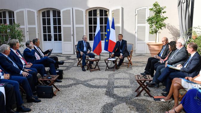 Presiden Prancis Emmanuel Macron (kanan) dan Presiden Rusia Vladimir Putin (kiri) menghadiri konferensi pers di Benteng Bregancon, Bormes-les-Mimosas, Prancis, Senin (19/8/2019). Macron dan Putin akan membahas krisis Ukraina, Iran, dan Suriah. (Gerard Julien, Pool via AP)