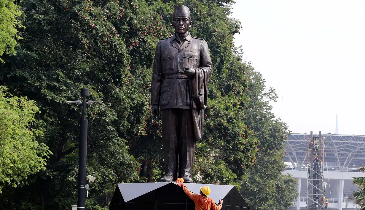 Pekerja membersihkan patung Presiden RI 1 Soekarno di depan Pintu 5 GBK, Jakarta, Rabu (11/7). Pemasangan Patung tersebut dilakukan jelang perhelatan bergengsi Asian Games pada 18 Agustus 2018 di Jakarta dan Palembang. (Liputan6.com/Johan Tallo)