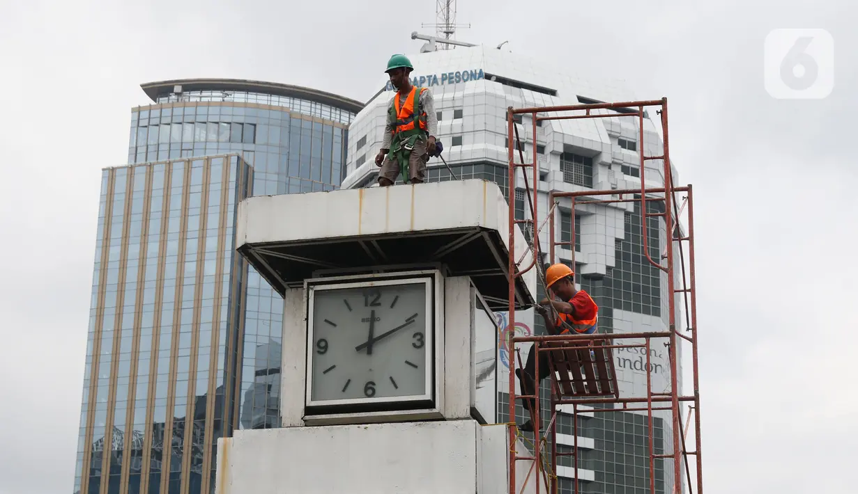 Petugas melakukan perawatan tugu jam yang berada di Merdeka Selatan, Jakarta, Minggu (2/2/2020). Perawatan tersebut dilakukan untuk pengecekan kondisi jam yang nantinya akan dipasangkan panel surya sebagai daya power agar tugu jam dapat berfungsi sebagai petunjuk waktu. (Liputan6.com/Angga Yuniar)