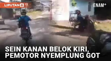 Entah apa yang ada dalam benak pemotor berikut. Terekam ia menyalakan lampu sein ke kanan, namun justru belok ke kiri. Ia malah jatuh ke got di tepi kanan usai belok.