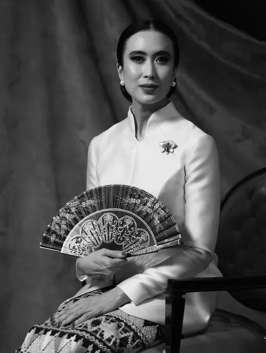 Tampilan sanggulnya terlihat lebih sleek yang perlihatkan anting yang dikenakan. Dengan posisi duduk tegak, Menpar Widi Wardhana memegang kipas yang terbuka [@widi.wardhana]