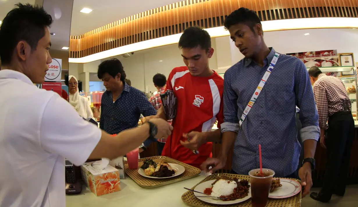 Zalnando (kiri) dan Zulfiandi saat bersantap siang seusai menjalankan ibadah sholat Jumat di daerah Bugis, Singapura. Jumat (5/6). (Bola.com/Arief Bagus)