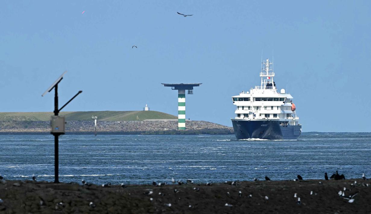 Kapal pesiar MV Hondius yang terdampak Hantavirus berlayar di lepas pantai Belanda saat mendekati pelabuhan Rotterdam pada Senin 18 Mei 2026. (NICOLAS TUCAT/AFP)