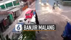 Kalah dengan kuatnya arus, pemotor nyaris jatuh namun ditolong pria berpayung.