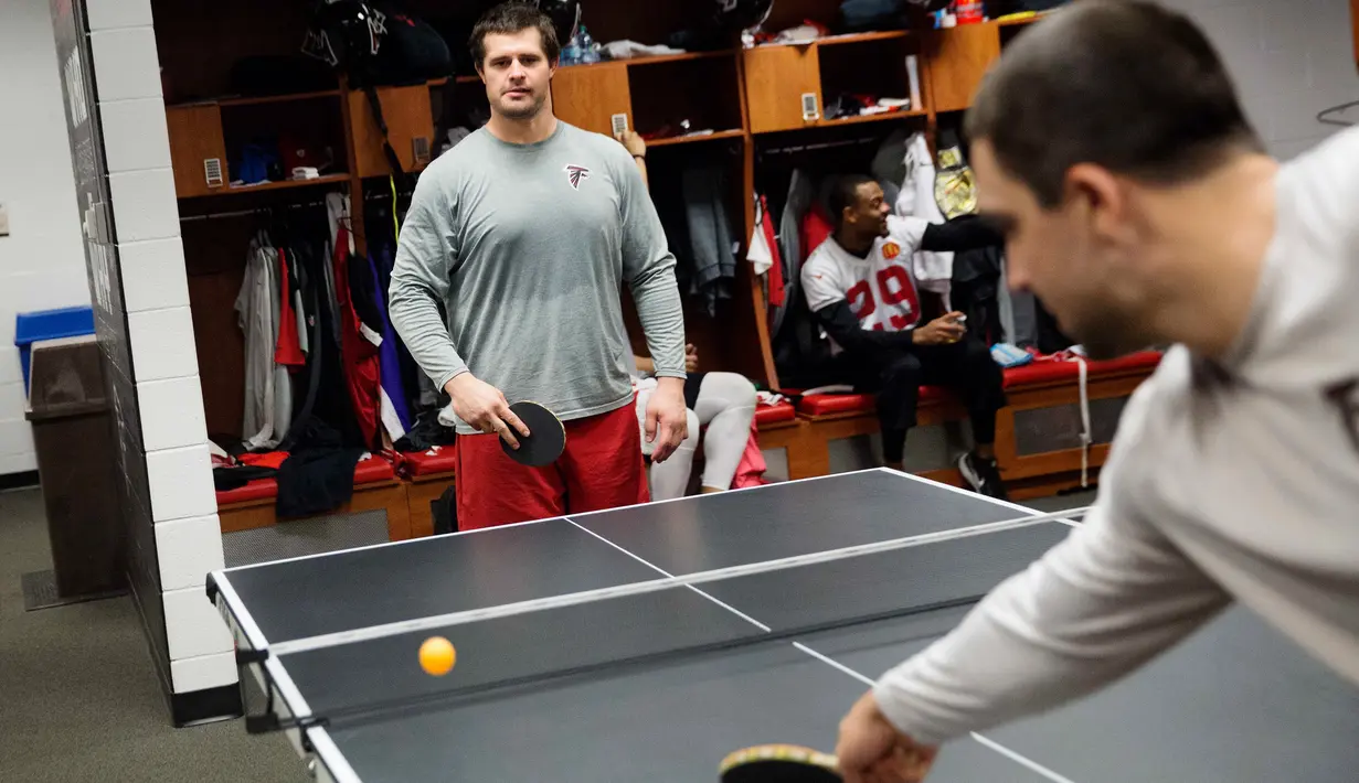 Pemain Atlanta Falcons, Andy Levitre (kiri) bermain tenis meja dengan rekan setimnya Josh Harris di ruang ganti di fasilitas latihan NFL football di Flowery Branch, Ga (26/1). Sebelum bertanding para pemain bermain tenis meja. (AP Photo/David Goldman)