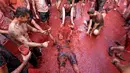 Seorang pria tergeletak digenangan tomat saat festival La Tomatina berlangsung di desa Bunol, Spanyol, Rabu (30/8). Peserta dibanderol sebesar 12 dollar atau 160 ribu rupiah untuk mengikuti rangkaian festival tersebut. (Alberto Saiz/AP)