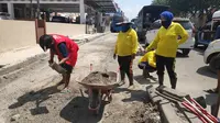 Pelanggar protokol kesehatan di Pekanbaru jalani sanksi sosial membersihkan jalan. (Liputan6.com/Pekanbaru)
