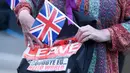 Pendukung Brexit memegang poster dan bendera Inggris di Westminster, London, Kamis (23/6). Perhitungan suara hasil Referendum Brexit menunjukkan mayoritas rakyat Inggris memilih “Brexit” alias keluar dari Uni Eropa. (REUTERS/Toby Melville)
