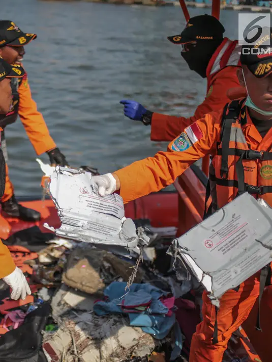Petugas Basarnas menunjukkan serpihan pesawat Lion Air JT 610 di Posko Evakuasi, Tanjung Priok, Jakarta, Senin (29/10). Pesawat Lion Air JT 610 dilaporkan hilang sekitar pukul 06.00 WIB. (Liputan6.com/Faizal Fanani)