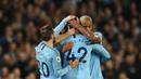 Para pemain Manchester City memeluk Yaya Toure usai laga melawan Brighton and Hove Albion di Stadion Etihad, Rabu (9/5/2018). Laga tersebut menjadi ajang perpisahan sang pemain bersama The Citizens. (AFP/Oli Scarff)