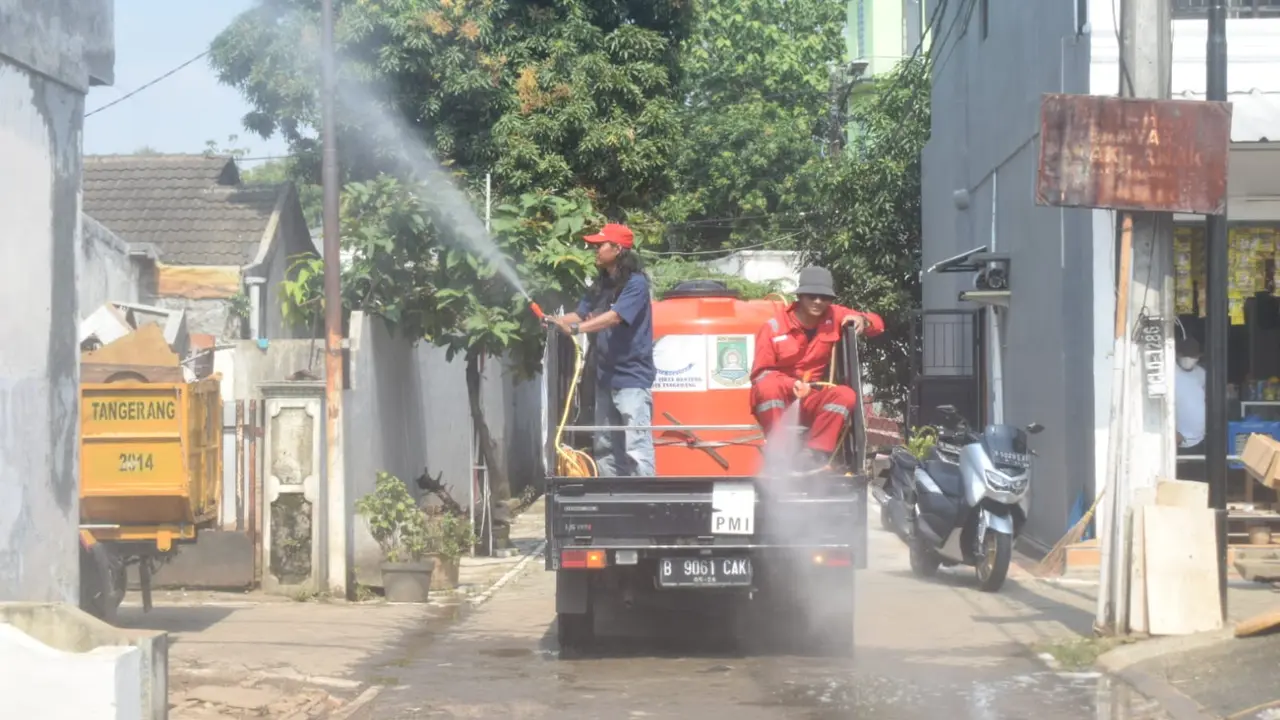 Relawan PMI menyemprotkan cairan Eco Enzim di  perumahan Puri Kartika, Kelurahan Tajur, Kecamatan Ciledug Kota Tangerang usai banjir yang menggenang di sejumlah perumahan. (Liputan6.com/Pramita Tristiawati)