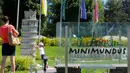 Seorang bocah berada di dekat miniatur Menara Pisa di Taman Minimundus, Klagenfurt, Austria, Senin (8/8). Taman Minimundus menampilkan aneka bangunan unik dari berbagai negara. (REUTERS/Heinz-Peter Bader)
