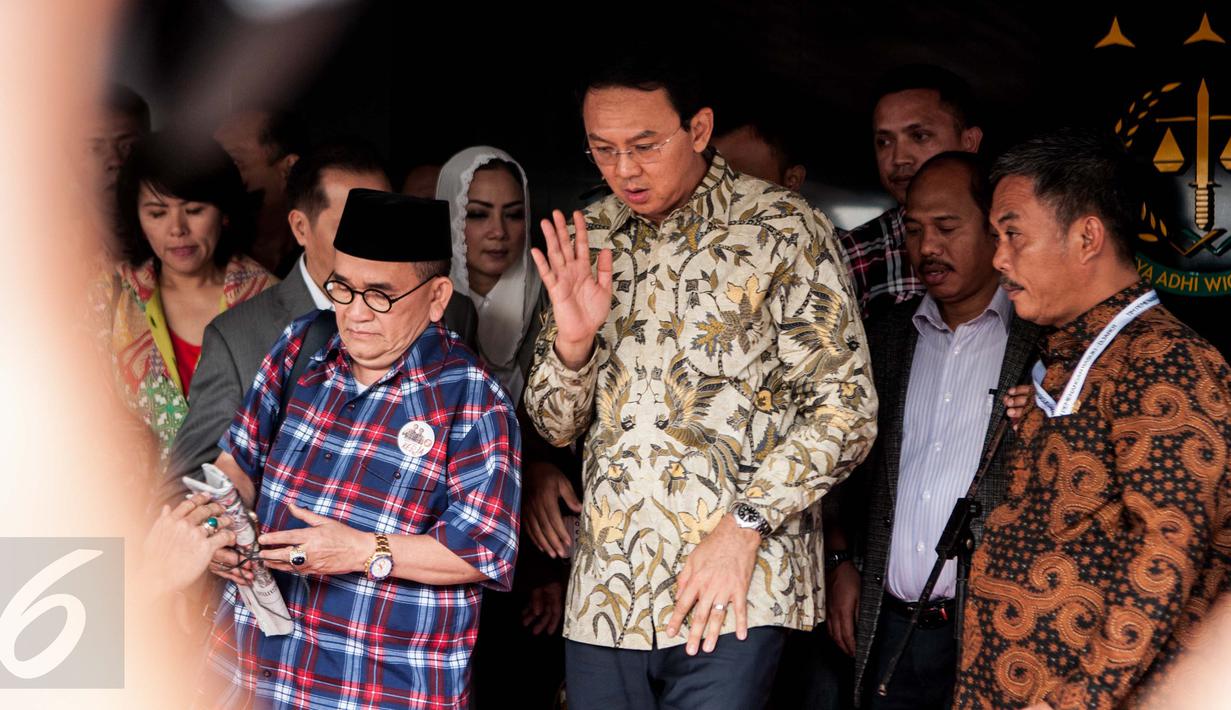 Basuki Tjahaja Purnama (Ahok) melambaikan tangan ke arah awak media saat akan meninggalkan Gedung Kejagung, Jakarta, Kamis (1/12). Ahok keluar dari Gedung Kejagung ditemani kuasa hukum serta tim pemenangan Ahok-Djarot. (Liputan6.com/Gempur M Surya)