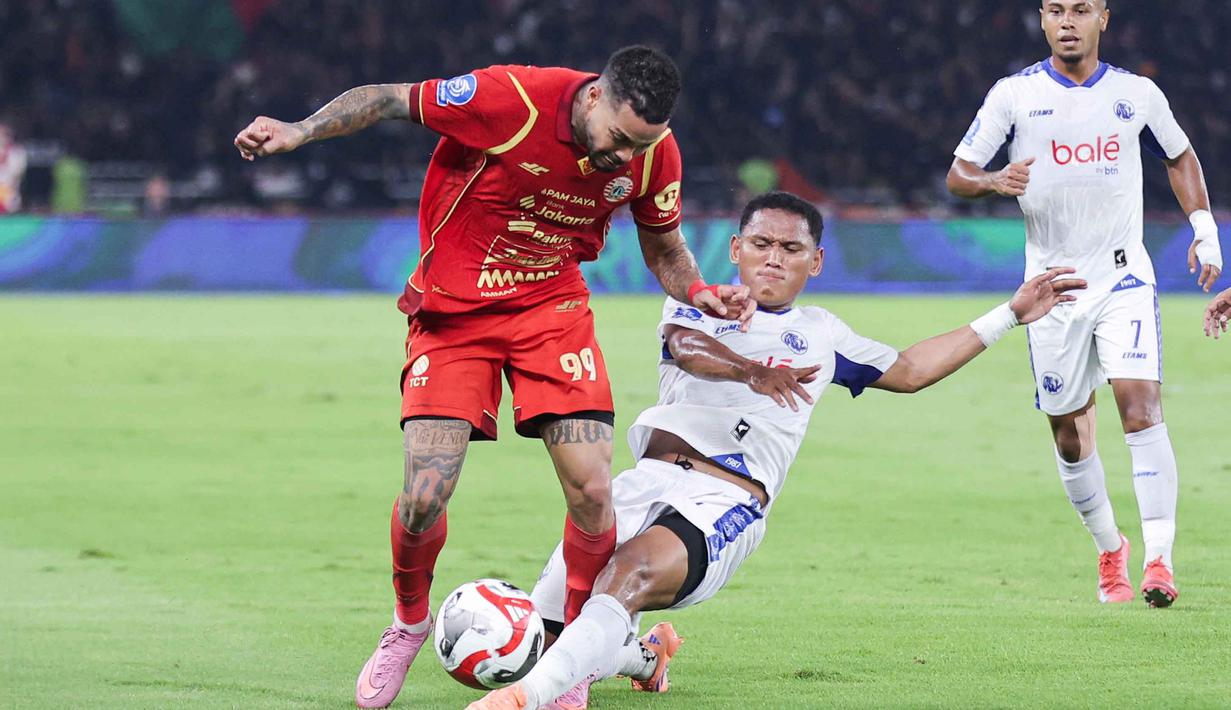 Bertanding di Stadion Utama Gelora Bung Karno, Jakarta, Minggu (8/2/2026), Persija Jakarta dipermalukan Arema Malang dengan skor 0-2. Tampak dalam foto, gelandang serang Persija, Emaxwell Souza De Lima (kiri) berebut bola dengan bek kiri Arema FC, Muhammad Iksan Lestaluhu saat pertandingan pekan ke-20 BRI Super League 2025/2026 di Stadion Utama Gelora Bung Karno, Jakarta, Minggu (8/2/2026). (Bola.com/Abdul Aziz)