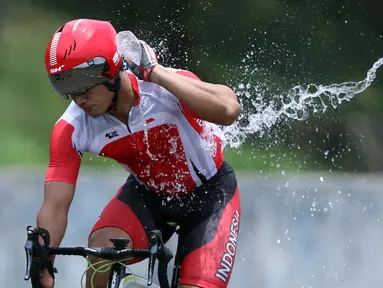 Atlet ParaCycling, Martin Losumengguyur tubuhnya saat laga di nomor Mens C5 Road RaceAsian Para Games 2018 di Sirkuit Sentul Bogor, Selasa (9/10). Martin Losu meraih perunggu dengan waktu 2 jam 18.58 menit. (Liputan6.com/Helmi Fithriansyah)