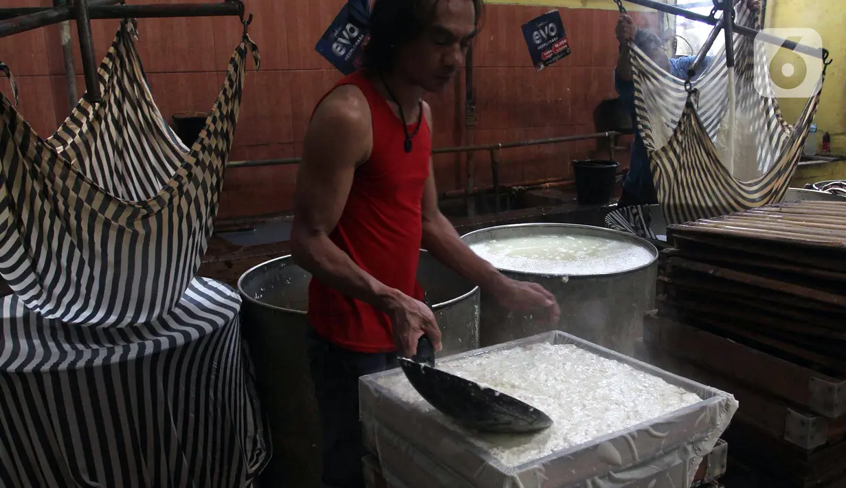 Pekerja menyelesaikan pembuatan tahu di kawasan Pondok Cabe Udik, Tangerang Selatan, Banten, Selasa (15/2/2022). Produsen tahu dan tempe akan menggelar aksi mogok produksi massal pada 21-22 Februari mendatang disebabkan kenaikan harga kedelai hingga mencapai Rp 11.200/kg. (merdeka.com/Arie Basuki)