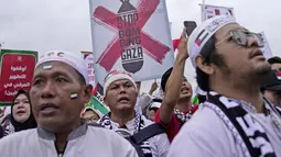 Terlihat massa aksi mengenakan pakaian serba putih dan hitam, dilengkapi berbagai atribut dengan warna selaras bendera Palestina. (AP Photo/Dita Alangkara)