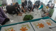 Anak berkebutuhan khusus (ABK) mengikuti pelatihan  ecoprint dari dedaunan  di Pasar Gintung, Tangerang Selatan, Banten, Selasa (13/6/2023). (merdeka.com/Arie Basuki)