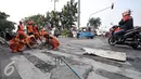 Jalan berlubang di kawasan Senen sedang ditambal oleh petugas, Jakarta, Selasa (26/7). Penambalan jalan berlubang ini bertujuan untuk kenyamanan pengguna jalan yang melintas. (Liputan6.com/Yoppy Renato)