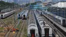 Pekerja mencuci rangkaian gerbong kereta yang terparkir di Depo Cipinang, Jakarta, Jumat (22/9/2023). Depo Cipinang menjadi tempat perawatan kereta terbesar di Indonesia dengan memiliki 28 jalur kereta. (merdeka.com/Imam Buhori)