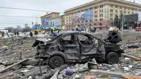 Sebuah mobil rusak di luar balai kota Kharkiv yang hancur akibat penembakan pasukan Rusia pada 1 Maret 2022. Alun-alun pusat kota terbesar kedua Ukraina, Kharkiv, dibombardir oleh pasukan Rusia -- menghantam gedung pemerintahan lokal -- kata gubernur Oleg Sinegubov. (Sergey BOBOK / AFP)