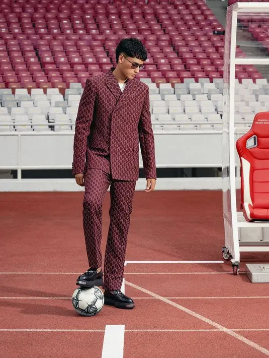 Rafael Struick mengambil pemotretan di lapangan Gelora Bung Karno. Ia tampil menawan mengenakan koleksi Fall/Winter 2024 brand Gucci. Ia tampil mengenakan jas dan celana warna maroon dengan motif logo Gucci. [@kacastuudio]