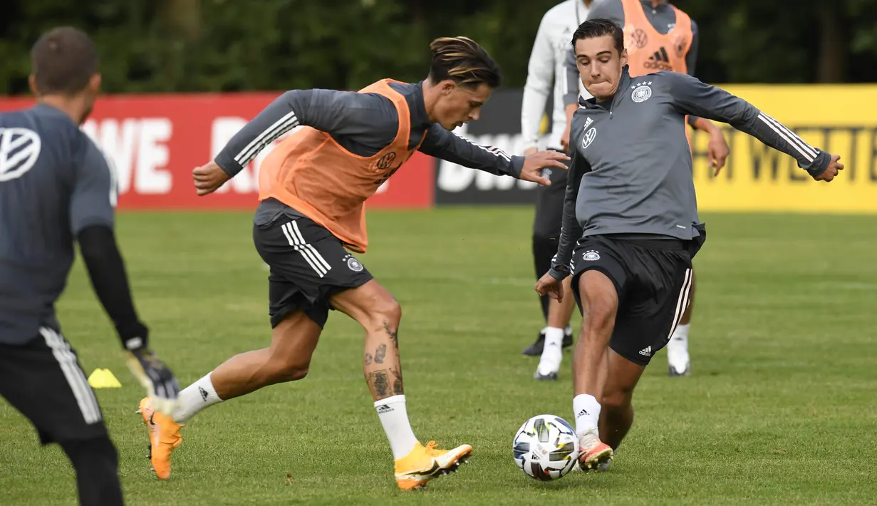 Pemain Timnas Jerman, Robin koch dan Florian Neuhaus, berebut bola saat sesi latihan jelang laga UEFA Nations League di Stuttgart, Senin (31/8/2020). Jerman akan berhadapan dengan Spanyol. (AFP/Thomas Kienzle)