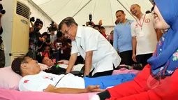 Wakil Presiden Jusuf Kalla (tengah) berbincang dengan salah satu pendonor darah di Bundaran HI, Jakarta, Minggu (29/3/2015). Acara donor darah diadakan serentak di 25 kota di tanah air bertujuan membudayakan aksi donor darah. (Liputan6.com/Panji Diksana)