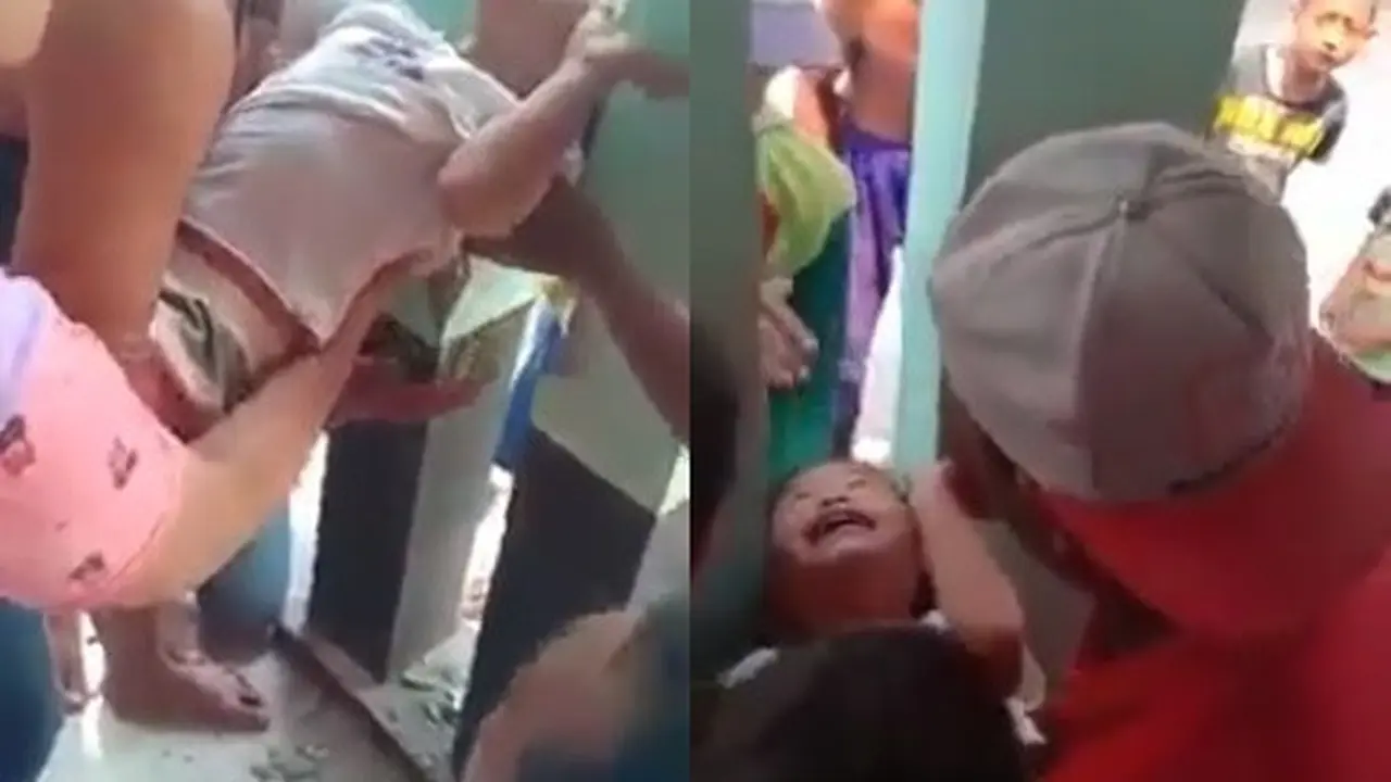 kepala bocah tersangkut di tembok