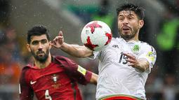 Striker Meksiko, Oribe Peralta, berusaha melewati bek Portugal, Neto, pada laga perebutan tempat ketiga Piala Konfederasi di Stadion Spartak, Moskow, Minggu (2/7/2017). Portugal menang 2-1 atas Meksiko. (EPA/Mario Cruz)