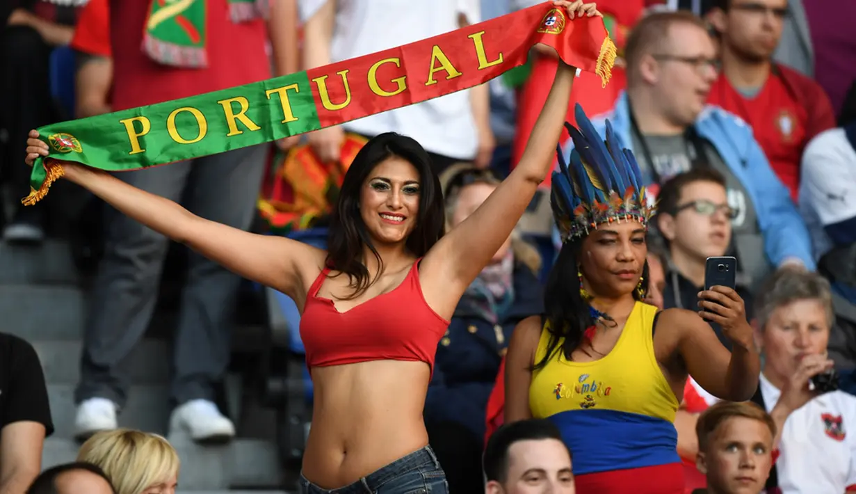 Aksi suporter Portugal saat melawan Austria pada laga kedua Grup F Piala Eropa 2016 di Parc des Princes, Minggu (19/6/2016) dini hari WIB. (AFP/Francisco Leong)