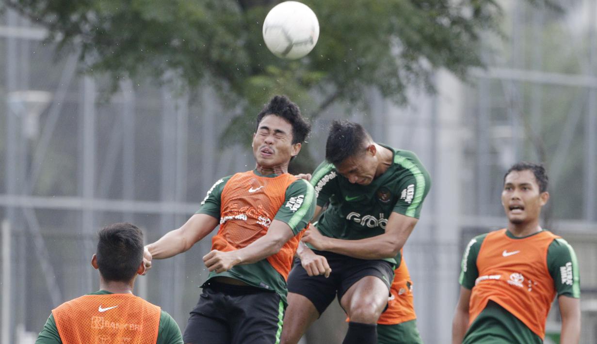 Pemain Timnas Indonesia U-22, Nurhidayat, duel udara dengan Andi Setyo, saat latihan di Lapangan ABC Senayan, Selasa (5/2). Nurhidayat merupakan palang pintu andalan yang siap menjaga pertahanan Timnas Indonesia U-22. (Bola.com/M Iqbal Ichsan)