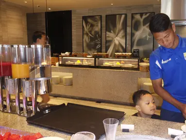 Pemain Persib, Achmad Jufriyanto, saat sarapan pagi bersama anaknya di Hotel Fairmont jelang Final Piala Presiden 2015, Minggu (18/10/2015) pagi WIB. (Bola.com/Vitalis Yogi Trisna)