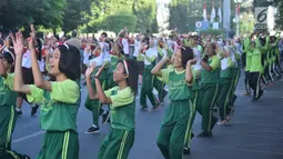 Gabungan peserta senam klosal menampilkan tari Gemu Famire untuk merayakan HUT ke-73 TNI di Simpang Lima Semarang, Selasa (4/9). Tari secara serentak di tiga zona waktu wilayah Indonesia itu melibatkan total 305 ribu orang. (Liputan6.com/Gholib)