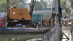 Petugas Dinas Sumber Daya Air Pemprov DKI Jakarta membangun turap di Kali Ciliwung Lama, Jakarta, Kamis (11/10). Pembangunan turap ini merupakan bagian dari proyek normalisasi Kali Ciliwung. (Merdeka.com/Iqbal Nugroho)