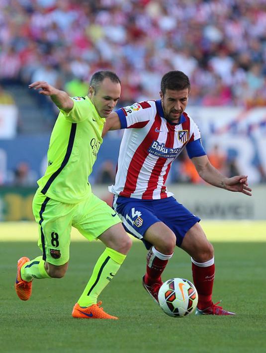 Gelandang Barcelona, Andres Iniesta (kiri) berebut bola dengan gelandang Atletico Madrid Gabi pada laga Liga Spanyol di Stadion Vicente Calderon, Senin (18/5/2015). Barcelona menang 1-0 atas Atletico Madrid. (AFP PHOTO/Cristina Quicler)