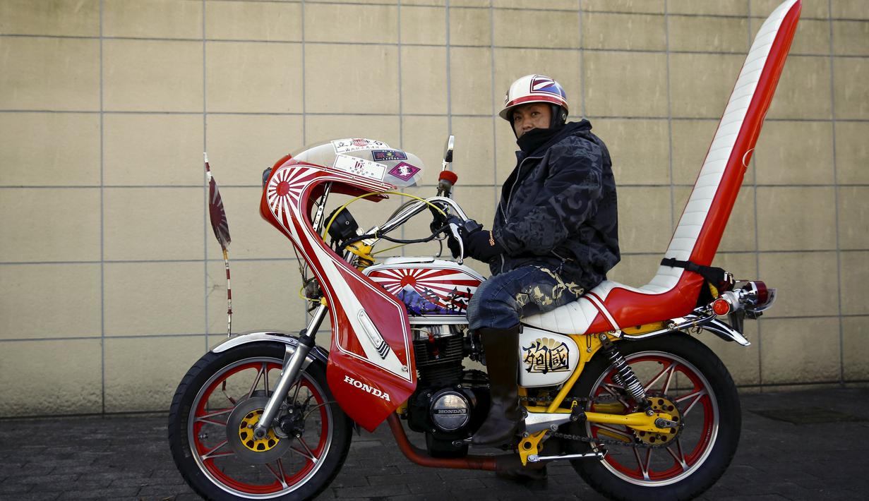 Seorang pemilik motor lama Bousouzoku saat sedang berhenti di daerah Yamanashi, Jepang , (3/1). Mesikpun motor tahun 1950-an ini ilegal berkendara di Jepang tetapi puluhan pengemudi motor ini tetap melakukan touring. (REUTERS / Thomas Peter)
