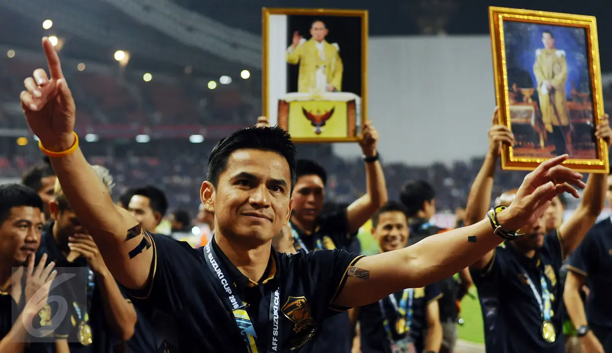 Pelatih Timnas Thailand, Kaitisuk Senamuang mengangkat tangan saat merayakan kemenangan atas Indonesia di National Stadium Rajamangala, Bangkok, Sabtu (17/12). Thailand berhasil meraih piala AFF untuk yang kelima kali. (Liputan6.com/Helmi Fithriansyah)