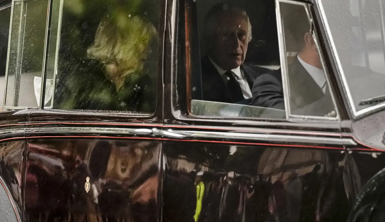 Raja Charles III dan Camilla, Permaisuri menuju Istana Buckingham di London, Selasa (13/9/2022). Peti mati Ratu Elizabeth II kembali ke Istana Buckingham pada Selasa malam, melewati London yang gerimis saat kerumunan orang memenuhi rute untuk melihat sekilas mobil jenazah dan mengucapkan selamat tinggal padanya.(AP Photo/Andreea Alexandru)